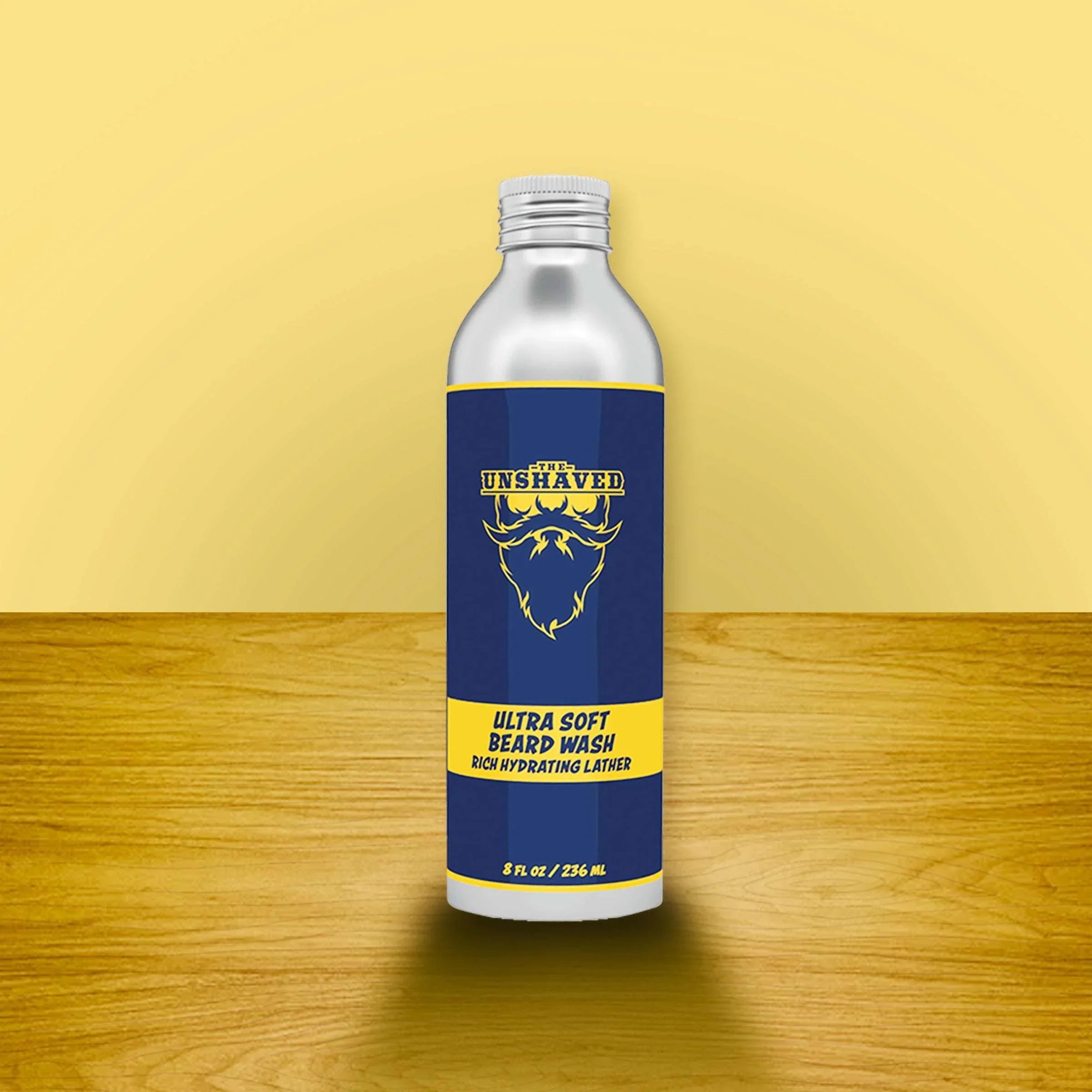 Ultra soft beard wash bottle with blue and yellow label on wooden surface, beard care product